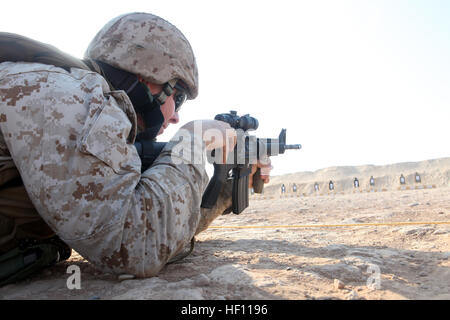 U.S. Marine Corps Staff Sgt. Charles M. Bates, maintenance management officer with 3rd Marine Aircraft Wing (Forward) loads an M4 carbine rifle on Camp Leatherneck, Helmand province, Afghanistan, Oct. 19, 2012. Bates conducted a battlefield zero to ensure his weapon functioned properly. (U.S. Marine Corps photo by Sgt. Keonaona C. Paulo/Released) 3rd MAW BZO 121019-M-EF955-366 Stock Photo