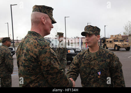 MARINE CORPS BASE CAMP PENDLETON, Calif. - Major Gen. John A. Toolan, Jr., commanding general of the 1st Marine Expeditionary Force, congratulates Hospitalman 1st Class Patrick B. Quill of 1st Marine Special Operations Battalion, U.S. Marine Corps Forces, Special Operations Command, after he is awarded the Silver Star, the nation's third-highest award for combat valor, by Secretary of the Navy Ray Mabus at a ceremony at 1st MSOB headquarters aboard Camp Pendleton, Calif. Dec. 4. Quill was recognized alongside Maj. James T. Rose and SSgt. Frankie J. Shinost, who also received Silver Stars, and  Stock Photo