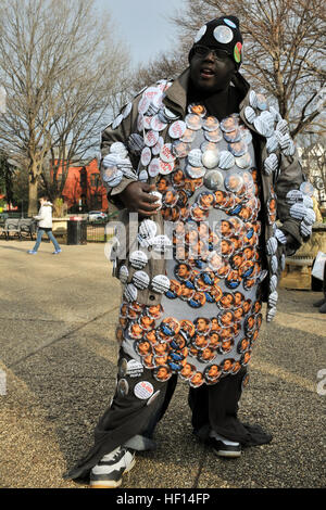 The 'Button Man' from the District of Columbia sells merchandise in front the Emancipation Memorial to people on their way to inauguration ceremonies. The Emancipation Memorial is a monument in Lincoln Park in the Capitol Hill neighborhood of Washington. The 57th Presidential Inauguration was held in Washington D.C. on Monday, Jan. 21, 2013. The inauguration included the Presidential Swearing-in Ceremony, Inaugural Address, Inaugural Parade and numerous inaugural balls and galas honoring the elected president of the United States. (Official U.S. Air Force photo by Tech. Sgt. Eric Miller/ New Y Stock Photo