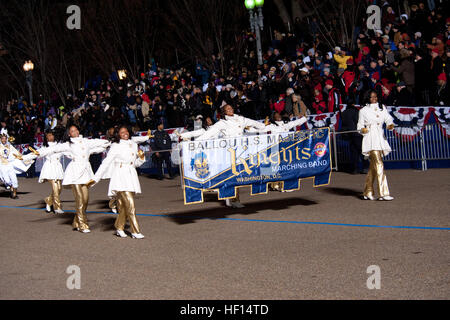 President Barack Obama watches the Ballou Senior High School majestic Marching Knights pass in front of the presidential inauguration parade official review stand. The 57th Presidential Inauguration was held in Washington on Monday, Jan. 21, 2013. The procession of more than 8,000 people that started at Constitution Avenue continued down Pennsylvania Avenue to the White House included ceremonial military regiments, citizen groups, marching bands and floats. The president, vice President, their spouses and special guests then review the parade as it passes in front of the presidential reviewing Stock Photo