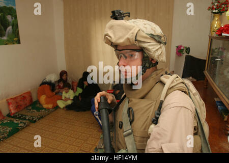 060425-M-9529D-024 Al Anbar Province, Iraq (April 25, 2006) - Hospitalman Dustin Horton assigned to the 3rd Battalion, 8th Marines, India Company, conducts security while marines of 3d Battalion, 8th Marines search a house, in Ar Ramadi in duration of Operation Iron Eagle. Operation Iron Eagle is a mission to deny insurgent freedom of movement, prevent Anti Coalition Forces from staging and conducting attacks against Coalition Forces and the Iraqi Army. U.S. Marine Corps photo by Lance Cpl. William L. Dubose III (RELEASED) Houseraidiraq Stock Photo