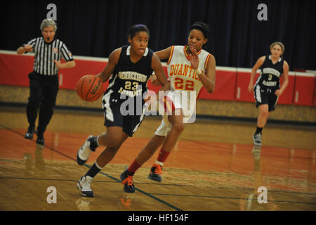 Brittany, Quantico Middle/High School Lady Warriors Varsity Basketball Team player, struggles to cover an opponent in the open court during a Delaney Athletic Conference game against the Fredericksburg Academy Falcons at Quantico on Jan. 30. The Falcons made a stand in the second half that brought them the game win, 37-18. (U.S. Marine Corps photo by Lance Cpl. Antwaun L. Jefferson/Released) Nothing left, intensity 130130-M-KX456-046 Stock Photo