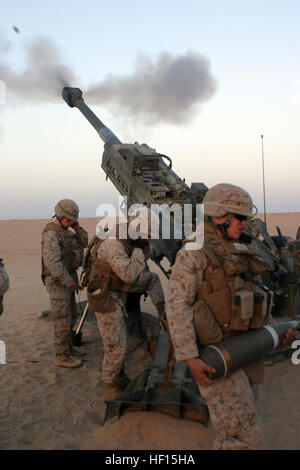 Marines from Artillery Battery, Lima Company, Battalion Landing Team 2/6, fire a round from an M777 155mm Lightweight Howitzer, Towed, during a firing mission conducted during sustainment training at Camp Buehring, Kuwait, Jan. 5, 2009. The 26th Marine Expeditionary Unit is currently deployed to the U.S. Central Command Area of Operation as part of its 2008-2009 deployment. Flickr - DVIDSHUB - Training at Camp Buehring Stock Photo