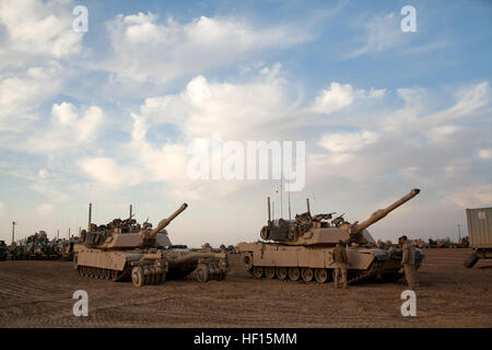 Two M1A1 Abrams tanks assigned Delta Company, 1st Tank Battalion are staged during a break in actions supporting Operation Dynamic Partnership in Shurakay, Helmand province, Afghanistan, Feb. 13, 2013. Dynamic Partnership was a multi-unit operation to retrograde all U.S. military equipment and personnel from village stability platform Shurakay. (U.S. Marine Corps photo by Cpl. Alejandro Pena/Released) Operation Dynamic Partnership Part Two 130213-M-YH552-282 Stock Photo