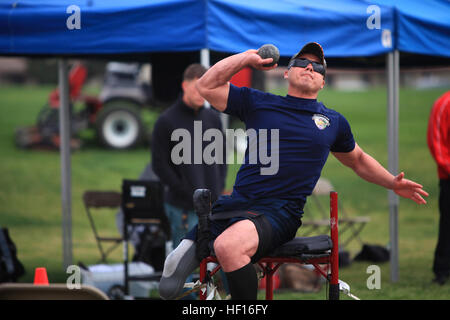 Sgt. Eric Rodriguez, with Wounded Warrior Battalion West, throws the shot put during the 2013 Marine Corps Trials aboard Camp Pendleton, Calif., March 5. Rodriguez, 30, from Los Angeles, was injured by an improvised explosive device on an over-watch mission with Scout Sniper Platoon, 1st Battalion, 8th Marine Regiment, in Afghanistan, Jan. 27, 2011. Rodriguez earned the Silver medal for the sitting shot put event and was selected to participate on the All-Marine Warrior Games Team.  The All-Marine Warrior Games Team will go head to head against the other branches of the Armed Forces May 11-17, Stock Photo