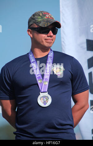 Sgt. Eric Rodriguez, with Wounded Warrior Battalion West, earned the Silver medal for the sitting shot put event at the 2013 Marine Corps Trials aboard Camp Pendleton, Calif., March 5. Rodriguez, 30, from Los Angeles, was injured by an improvised explosive device on an over-watch mission with Scout Sniper Platoon, 1st Battalion, 8th Marine Regiment, in Afghanistan, Jan. 27, 2011. 2013 Marine Corps Trials takes on track & field 130305-M-PF875-006 Stock Photo