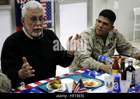 CAMP TAQADDUM, Iraq (Nov. 11, 2006) - Retired Marine Capt. John J. McGinty III, one of the 111 living Medal of Honor recipients, talks about his combat experiences with Petty Officer 3rd Class Freddy Chavez, a 21-year-old from Los Angeles and a hospital corpsman with Medical Logistics Company, Supply Battalion, Combat Logistics Regiment 15, 1st Marine Logistics Group (Forward). McGinty and two other recipients offered words of encouragement to those serving at Camp Taqaddum, Iraq, and orchestrated an unofficial Medal of Honor presentation ceremony here for Cpl. Jason L. Dunham, a Marine who ma