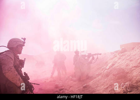 Marines with Company K, Battalion Landing Team 3/2, 26th Marine Expeditionary Unit (MEU), assault through a smokescreen during a mechanized raid with soldiers from the Royal Army of Oman during Exercise Sea Soldier 2013 in Rabkut, Oman, April 29, 2013. The 26th MEU is currently deployed as part of the Kearsarge Amphibious Ready Group to the 5th Fleet area of responsibility. The 26th MEU operates continuously across the globe, providing the president and unified combatant commanders with a forward-deployed, sea-based quick reaction force. The MEU is a Marine Air-Ground Task Force capable of con Stock Photo