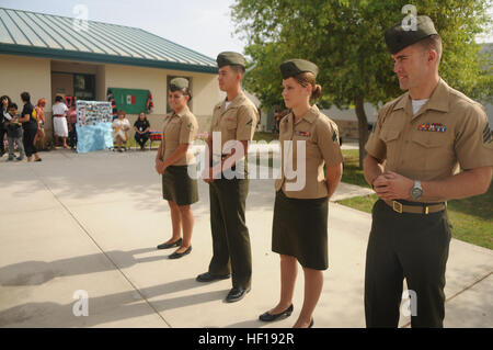 Sgt. Kelly Ryan Jackson, Marine Attack Squadron 211 tool room NCOIC and a native of Lubbock, Texas (right); Cpl. Lusetta Elise Lopez, a VMA-211 corrosion control specialist and a native of Spokane, Wash. (center right); LCpl. Gorge Flores Jr., a VMA-211 egress mechanic and a native of Hamilton, Ohio (center left); and LCpl. Marista Ann Dryden, a VMA-211 aviation mechanic and a native of Flint, Mich. (left), represented the Wake Island Avengers, based out of Marine Corps Air Station Yuma, and were recognized at George Carver Elementary School's end of the year Cinco De Mayo celebrations, May 3. Stock Photo