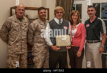 Mitchell P. January, center, recipient of the Officers' Wives' Club's scholarship, stands with his Parents, Lt. Col. Jan January, second from the left, Jenny January, second from the right, Maj. Gen. Steven Busby, left, commanding general of 3rd Marine Aircraft Wing, and Col. John P. Farnam, right, commanding officer of Marine Corps Air Station Miramar, at the 2013 Year-End Reception at the commanding general's house aboard MCAS Miramar, Calif., May 7. More than $5,000 were awarded in scholarships. Wives help Marine children go to college 130507-M-RB277-093 Stock Photo