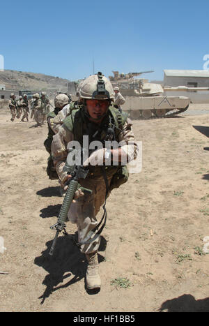 Canadian soldiers serving with 2nd Battalion, Royal 22nd Regiment, move into an urban training course while a M1A1 Abrams tank provides security during Exercise Dawn Blitz here, June 21, 2013.  Canadian soldiers coordinated movements with Marines from 1st Tank Battalion to clear the mock village of enemy role players. Dawn Blitz 2013 is a multinational amphibious exercise off the Southern California coast that refocuses Navy and Marine Corps and coalition forces in their ability to conduct complex amphibious operations essential for global crisis response across the range of military operation Stock Photo