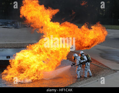 U.S. Senior Airman Larry Thompson and Airman 1st Class Nathan Smalkoski extenguish a plane fire during the Patriot Exercise at Volk Field in Camp Douglas, Wis., July 17, 2013. Patriot Exercise is a domestic operations scenario to assess the National Guard's ability to assist state and local agencies in response to multiple emergencies. More than 1,100 U.S. Service members and civil authorities, to include the FBI, Department of Health and Human Services and a variety of state agencies, were to participate in the exercise. (U.S. Army National Guard photo by Staff Sgt Michael Monroe/Released) Pa Stock Photo