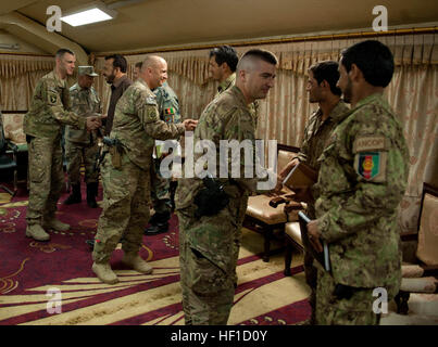 U.S. Army soldiers from 1st Brigade Combat Team, 101st Airborne Division, and their colleagues from 4th BCT, 10th Mountain Div., shake hands with their counterparts from the Afghan Border Police and Afghan National Civil Order Police following an intelligence meeting at Forward Operating Base Fenty, Nangarhar province, Afghanistan, July 22, 2013. During the meeting, the outgoing American intelligence officer/S2 from the 101st introduced the Afghans to his replacement from 10th Mtn. The briefing covered security concerns for Zone 1, which is comprised of the Nangarhar, Nuristan and Kunar provin Stock Photo