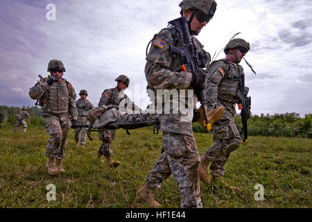 Ohio National Guard soldiers of 2nd Squadron, 107th Cavalry Regiment, headquartered in Hamilton, Ohio, litter carry a simulated wounded soldier during a combined-arms exercise held at the Infantry Squad Battle Course at Camp Atterbury, near Edinburgh, Ind., Aug. 12. The combined-arms, live-fire exercise was the culmination of two years of planning, preparation and training that integrated snipers, scouts, mortars, infantry and medics. (U.S. Army photo by John Crosby, Camp Atterbury Public Affairs) Ohio cavalry soldiers get back to basics at Atterbury 130812-Z-MG787-025 Stock Photo