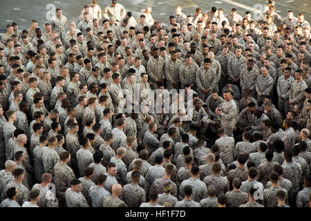 U.S. Marines assigned to the 26th Marine Expeditionary Unit (MEU), listen to U.S. Marine Corps. Lt. Col. Kevin Collins, commanding officer of Combat Logistics Battalion 26, 26th MEU, as he gives a liberty brief on the flight deck of the USS San Antonio (LPD 17), Sept. 6, 2013. The 26th MEU is a Marine Air-Ground Task Force forward deployed to the U.S. 5th  and 6th Fleet areas of responsibility aboard the Kearsarge Amphibious Ready Group serving as a sea-based, expeditionary crisis response force capable of conducting amphibious operations across the full range of military operations. (U.S. Mar Stock Photo