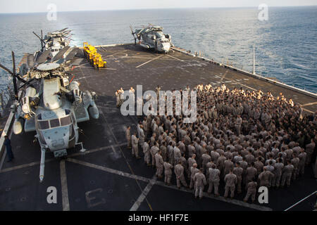 U.S. Marines assigned to the 26th Marine Expeditionary Unit (MEU), listen to U.S. Marine Corps. Lt. Col. Kevin Collins, commanding officer of Combat Logistics Battalion 26, 26th MEU, as he gives a liberty brief on the flight deck of the USS San Antonio (LPD 17), Sept. 6, 2013. The 26th MEU is a Marine Air-Ground Task Force forward deployed to the U.S. 5th and 6th Fleet areas of responsibility aboard the Kearsarge Amphibious Ready Group serving as a sea-based, expeditionary crisis response force capable of conducting amphibious operations across the full range of military operations. (U.S. Mari Stock Photo