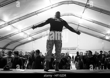 Staff Sgt. Michael Riggs, a drill instructor with Marine Corps Recruit Depot San Diego's Drill Instructor School, leads enlistees in a warm-up during Marine Corps Recruiting Station Seattle's Sergeant Major Pool Function on Joint Base Lewis-McChord in Tacoma, Wash., Sept. 28, 2013. During the event, Washington-based recruiters teamed with the drill instructors to physically and mentally prepare enlistees for boot camp. The enlistees, part of the Marine Corps delayed entry program, are awaiting their ship dates. Riggs, 29, is from Long Beach, Calif. Marine recruiters, drill instructors prepare  Stock Photo