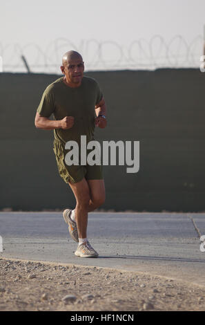 Master Sgt. Marcelino Marquez, Jr., a Marine with Combat Logistics Regiment 2, Regional Command (Southwest), runs a half marathon at Camp Leatherneck, Helmand province, Afghanistan, Oct. 10, 2013. The Marines ran the Jazz Half Marathon to support the cancer program at Children's Hospital in New Orleans, where the official half marathon will take place Oct. 12. Deployed Marines run to support ChildrenE28099s Hospital in New Orleans 131010-M-ZB219-022 Stock Photo