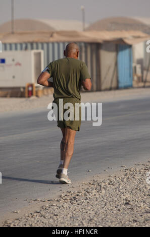 Master Sgt. Marcelino Marquez, Jr., a Marine with Combat Logistics Regiment 2, Regional Command (Southwest), runs a half marathon at Camp Leatherneck, Helmand province, Afghanistan, Oct. 10, 2013. The Marines ran the Jazz Half Marathon to support the cancer program at Children's Hospital in New Orleans, where the official half marathon will take place Oct. 12. Deployed Marines run to support ChildrenE28099s Hospital in New Orleans 131010-M-ZB219-367 Stock Photo