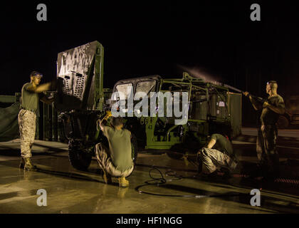 U.S. Marines assigned to Kilo Battery, Battalion Landing Team 3/2, 26th Marine Expeditionary Unit (MEU), clean an Internal Transport Vehicle during the 26th MEU’s wash-down, Naval Station Rota, Spain, Oct. 14, 2013. The 26th MEU is a Marine Air-Ground Task Force forward deployed to the U.S. 5th and 6th Fleet areas of responsibility aboard the Kearsarge Amphibious Ready Group serving as a sea-based, expeditionary crisis response force capable of conducting amphibious operations across the full range of military operations. (U.S. Marine Corps photo by Lance Cpl. Juanenrique Owings, 26th MEU Comb Stock Photo