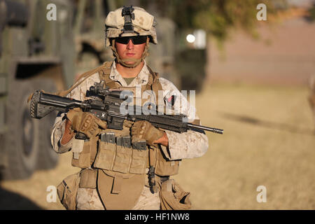 MARINE CORPS AIR STATION YUMA, Ariz. – Private First Class Cameron Cassavaugh, rifleman, Bravo Company, 1st Battalion, 7th Marine Regiment, and a native of Concord, N.H., provides security during a noncombatant evacuation operation training exercise here, Oct. 18, 2013. The Bravo Co. Marines and corpsmen treated ill or injured role-players during the exercise and also provided food and water. NEOs are conducted to assist in evacuating noncombatants, service members and third country nationals from locations in a host foreign nation to an appropriate safe haven or the United States when they ar Stock Photo