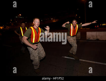 U.S. Marines and sailors assigned to the 26th Marine Expeditionary Unit (MEU) conduct a noncommissioned officer and staff noncommissioned officer run aboard U.S. Naval Station Rota, Spain, Oct. 22, 2013. The 26th MEU is a Marine Air-Ground Task Force forward-deployed to the U.S. 6th Fleet area of responsibility aboard the Kearsarge Amphibious Ready Group serving as a sea-based, expeditionary crisis response force capable of conducting amphibious operations across the full range of military operations. (U.S. Marine Corps photo by Sgt. Christopher Q. Stone, 26th MEU Combat Camera/Released) 26th  Stock Photo