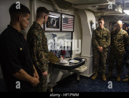 U.S. Marines and Sailors assigned to the 26th Marine Expeditionary Unit (MEU), take a moment of silence to remember prisoners of war and service members missing in action during the 238th Marine Corps birthday cake-cutting ceremony on the mess-deck of the USS San Antonio (LPD 17), at sea, Nov. 3, 2013. The 26th MEU is a Marine Air-Ground Task Force forward deployed to the U.S. 6th Fleet area of responsibility aboard the Kearsarge Amphibious Ready Group serving as a sea-based, expeditionary crisis response force capable of conducting amphibious operations across the full range of military opera Stock Photo