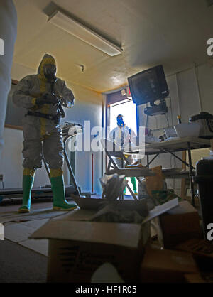 Explosive ordnance disposal technicians at Marine Corps Air Station Yuma conduct training in SCBA and chemical protective suits to identify and mitigate threats in a simulated clandestine lab scenario. Stock Photo