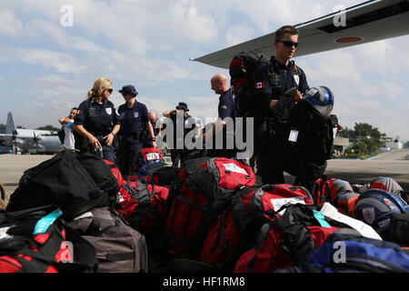 Emergency Response /Search and Rescue team (ERT) wait to board C-130H Hercules aircraft on Villamor Air Base, Manila, Republic of the Philippines, Nov. 20, 2013.  The ERT members are traveling to heavily affected areas in the Philippines to help rescue survivors of Typhoon Haiyan during Operation Damayan.  (U.S. Marine Corps photo by Lance Cpl. Jeraco Jenkins/Released) Operation Damayan 131120-M-CV548-005 Stock Photo