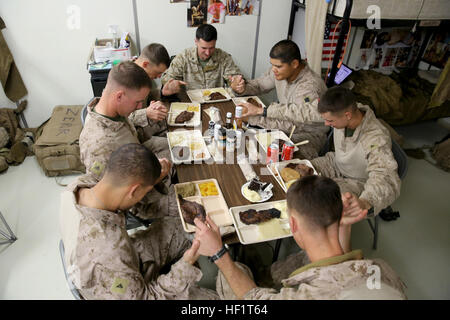 DELROM, Afghanistan – Marines serving with 3rd Battalion, 7th Marine Regiment’s Security Force Advisor Team pray before they enjoy their Thanksgiving dinner here, Nov. 28, 2013. The Marines gathered together and bonded as they shared family traditions with one another. 3-7 Marines bond during Thanksgiving (Image 5 of 5) (11176909203) Stock Photo