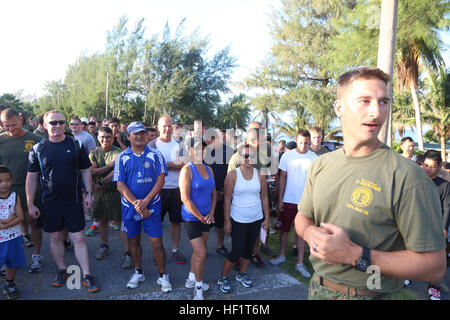 1st Lt. Alex Cloninger explains the course for the 2nd Tinian Hafa Adai 5K run to participants waiting at the starting line Nov. 30. 'So many Marines, sailors and local residents came out and helped with a very motivating run,' said Cloninger. 'This is the second time we have done this and it keeps getting better and better.' Cloninger is a motor transportation officer with Marine Wing Support Squadron 171, Marine Aircraft Group 12, 1st Marine Aircraft Wing, III Marine Expeditionary Force. The service members currently on Tinian participating in Exercise Forager Fury II, which is a joint exerc Stock Photo