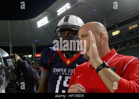 Quentin Gibson, from Archbishop Shaw High School in Marrero, La., talks with his coach during the Semper Fidelis All-American bowl in Carson, Calif., Jan. 5. The Bowl brings selected players together with U.S. Marines and football coaches to develop skills not only important to football, but throughout life, such as leadership, self-confidence and teamwork. (U.S. Marine Corps photo by Sgt. Andres J. Lugo/released) Semper Fidelis All-American Bowl Game Time 140105-M-QG862-883 Stock Photo