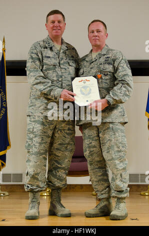 Kentucky's adjutant general, Maj. Gen. Edward W. Tonini, presents Tech. Sgt. Christopher Terrell, an explosive ordnance disposal technician from the 123rd Civil Engineer Squadron, with the Air Force Combat Action Medal during an award ceremony held Jan. 12, 2014, at the Kentucky Air National Guard Base in Louisville, Ky. Terrell earned the award for participating in direct combat while deployed to Afghanistan in 2011. (U.S. Air National Guard photo by Airman 1st Class Joshua Horton) Kentucky airmen honored for heroism and service in Afghanistan 140112-Z-DI861-230 Stock Photo