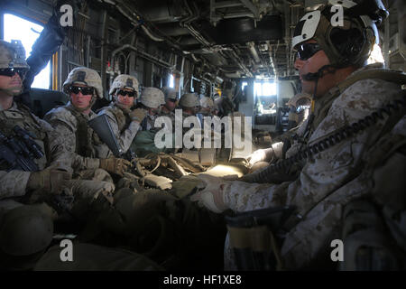 Marines with Bravo Company, 1st Battalion, 7th Marine Regiment, wait inside a CH-53E super sea stallion helicopter as they are transported to their next objective at Marine Corps Air Ground Combat Center Twentynine Palms, Calif., Feb. 3, 2014. Marines were inserted two kilometers from Lava Training Area where they had to fire and maneuver across rough terrain to an objective and set up defensive positions. After defending the area for 36 hours, the infantrymen repelled an enemy night attack and executed a counterattack across five kilometers to conclude the three-day training exercise.  (U.S.  Stock Photo