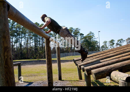 Cpl. Joshua Munro, a Troy, Mich., native and student at 2nd Marine Logistics Group's Corporal's Course, jumps onto an obstacle during one of the course's daily fitness sessions at Camp Lejeune, N.C., March 20, 2013. Munro, originally a machine gunner by trade, took the course to help further his leadership abilities through formal education in Marine Corps history and traditions. CorporalE28099s Course forges next generation of Marine NCOs 140320-M-ZB219-006 Stock Photo