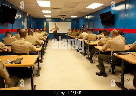 An instructor at 2nd Marine Logistics Group's Corporal's Course, prepares his students for their final written exam during their third week of training at Camp Lejeune, N.C., March 21, 2014. The instructors at the course spent four weeks drilling the Marines on everything from combat operations to Marine Corps traditions and history. CorporalE28099s Course forges next generation of Marine NCOs 140321-M-ZB219-001 Stock Photo