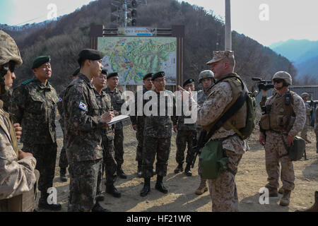 U.S. Marines with Delta Battery, 2d Battalion, 14th Marines, 14th Marine Regiment, assigned to Marine Expeditionary Force, answer questions from the Republic of Korea Marines key personnel about the High Mobility Artillery Rocket Systems (HIMARS) during a Combined Joint Live Fire Exercise (CJLFEX), at Rodriguez Range, South Korea, Mar. 62014. This is the first time HIMARS have been deployed and fired within the Republic of Korea. (U.S. Marine Corps photo by Cpl. Lauren Whitney/Released) Combined Joint Live Fire Exercise (CJLFEX) 140326-M-GZ082-083 Stock Photo