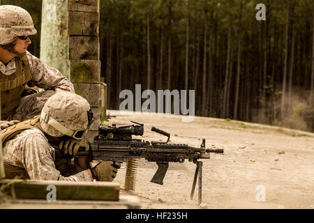 A Marine with 8th Engineer Support Battalion, 2nd Marine Logistics Group releases a burst from an M-249 Squad Automatic Weapon during a live-fire range at Camp Lejeune, N.C, April 14, 2014. The battalion spent several hours training its Marines to be proficient with a variety of machine guns they may encounter on the modern battlefield. (U.S. Marine Corps photo by Cpl. Shawn Valosin) 8th ESB stays sharp on the trigger 140414-M-IU187-003 Stock Photo