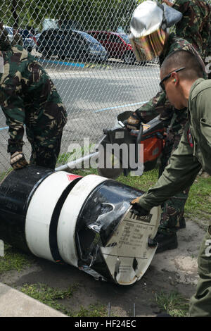 Philippine Air Force Tech. Sgt. Arthuro Sumilhig uses a K-12 rescue saw to cut through a barrel while U.S. Marine Corps Lance Cpl. Jesus Covarrubias holds it steady during a Balikatan 2014 training event May 6, 2014, at Clark Air Base, Philippines. In its 30th year, Balikatan is an annual training exercise that strengthens the interoperability between the Armed Forces of the Philippines and U.S. military in their commitment to regional security and stability, humanitarian assistance and disaster relief. The training is part of a series of combined events aimed to improve the effectiveness betw Stock Photo