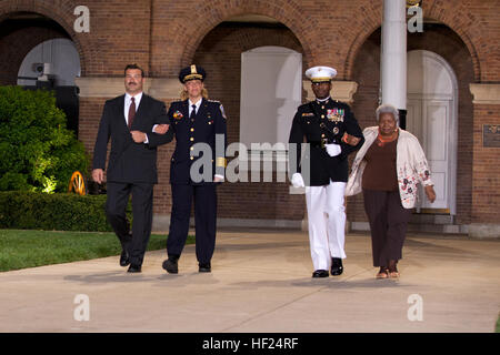 From left, U.S. Park Police Capt. Charles Guddemi; the Evening Parade guest of honor, Metropolitan Police Department Chief Cathy L. Lanier; the parade host, U.S. Marine Lt. Gen. Ronald L. Bailey, deputy commandant of Plans, Policies, and Operations; and Martha Bailey, walk down center walk during an Evening Parade at Marine Barracks Washington in Washington, D.C., May 9, 2014. The Evening Parades are held every Friday night during the summer months. (U.S. Marine Corps photo by Lance Cpl. Samantha Draughon/Released) Evening Parade 140509-M-EL431-321 Stock Photo