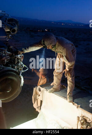 A U.S. Marine Corporal Anthony Betancourt, an M1A1 Abrams tank crewman assigned to Delta Company, 1st Tank Battalion, 1st Marine Division guides the engine of an M1A1 Abrams tank into place after repairs were completed during Desert Scimitar, May 12, 2014 aboard Marine Corps Air Ground Combat Center, Twentynine Palms, California. Desert Scimitar 2014 was a 1st Marine Division exercise held to test and refine its command and control capabilities by acting as the headquarters element for a forward-deployed Marine Expeditionary Force simultaneously offering units the opportunity to hone their con Stock Photo