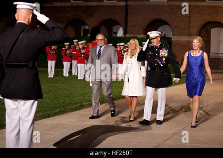 From left, the Evening Parade guest of honor, Bob Parsons; Renee Parsons; the Evening Parade host, Deputy Commandant for Programs and Resources Lt. Gen. Glenn M. Walters; and Gail Walters, walk down center walk during the parade at Marine Barracks Washington in Washington, D.C., May 16, 2014. The Evening Parades are held every Friday night during the summer months. (U.S. Marine Corps photo by Cpl. Michael C. Guinto/Released) Evening Parade 140516-M-LI307-225 Stock Photo