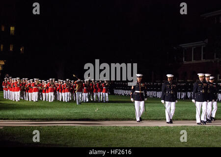 U.S. Marines march in a pass in review on the parade deck during an Evening Parade at Marine Barracks Washington in Washington, D.C., May 16, 2014. The Evening Parades are held every Friday night during the summer months. (U.S. Marine Corps photo by Lance Cpl. Alejandro Sierras/Released) Evening Parade 140516-M-GK605-428 Stock Photo