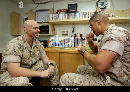 U.S. Navy Religious Program Specialist 2nd Class Leonard Rader, left, Battalion Landing Team (BLT) 1st Battalion, 6th Marine Regiment, 22nd Marine Expeditionary Unit (MEU), religious program manager and native of Gibsonville, N.C., and U.S. Marine Corps Sgt. Jesus Cruz, right, BLT 1/6, 22nd MEU, forward observer and native of New Britian, Conn., play a game of cards aboard the USS Bataan (LHD 5). The 22nd MEU is deployed with the Bataan Amphibious Ready Group as a theater reserve and crisis response force throughout U.S. Central Command and the U.S. 5th Fleet area of responsibility. (U.S. Mari Stock Photo