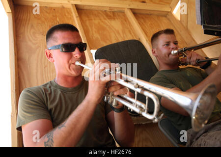 Sgt. Jason Comfort, a 2007 graduate of West Land High School, rehearses with other band Marines with Headquarters Battalion, 1st Marine Division (Forward) at Camp Leatherneck, Afghanistan, June 22. The West Land, Ore. native and fellow bandsmen take on many jobs while deployed, such as armorers, camp sentries and supply clerks. Band members practice while deployed DVIDS294409 Stock Photo