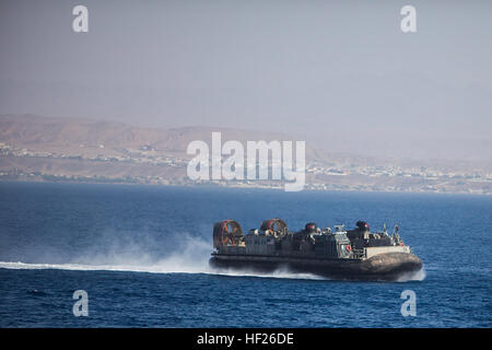 A U.S. Navy landing craft, air cushion returns to the USS Bataan (LHD 5) after transporting U.S. Marines and vehicles with Battalion Landing Team 1st Battalion, 6th Marine Regiment, 22nd Marine Expeditionary Unit (MEU), to Jordan in preparation for Exercise Eager Lion 2014. Exercise Eager Lion 2014 is a recurring, multinational exercise designed to strengthen military-to-military relationships and enhance regional security and stability by responding to modern-day security scenarios. The 22nd MEU is deployed with the Bataan Amphibious Ready Group as a theater reserve and crisis response force  Stock Photo