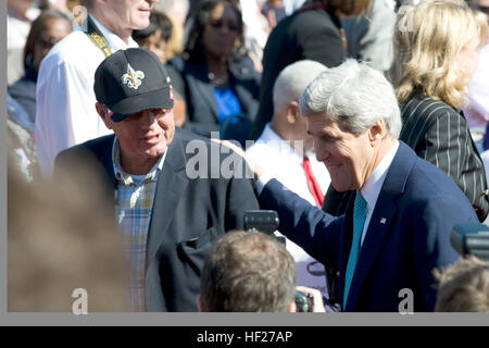 U.S. Secretary of State John Kerry meets with attendees at the Normandy American Cemetery and Memorial in Colleville-sur-Mer, Normandy, France, June 6, 2014, before a ceremony commemorating the memory of the Soldiers who gave their lives 70 years ago fighting to end the Nazi occupation of Europe. During the ceremony U.S. President Barack Obama and French President Fran?ois Hollande spoke to more than 10,000 attendees, including approximately 400 World War II veterans. The morning of June 6, 1944, Allied forces conducted a massive airborne assault and amphibious landing in the Normandy region o Stock Photo