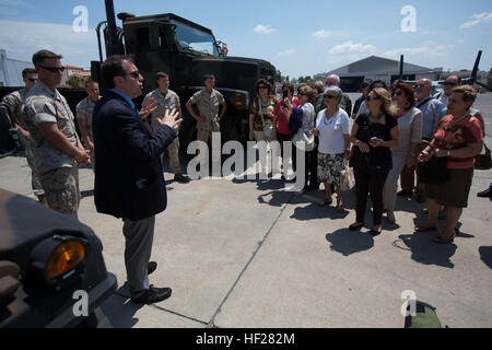 Alberto Lunetta, Community Relations Officer, Naval Air Station Sigonella, gives opening comments to a local tour group, June 15th, 2014 at Naval Air Station, Sigonella, Italy.  For the tour, Special Purpose Marine Air-Ground Task Force (SPMAGTF)-Africa and SPMAGTF -Crisis Response showcased their 7-ton trucks, Explosive Ordnance Disposal (EOD) bomb suits, EOD robots, MV-22 Ospreys and KC-130s.  (Official Marine Corps photo by Staff Sgt. Tanner M. Iskra, SPMAGTF-AF, 2nd Marine Division Combat Camera/Released) Local Sicilian Lion's Club Tour SPMAGTF-AF and SPMAGTF-CR Capabilities 140615-M-DG801 Stock Photo