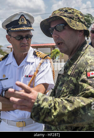 Capt. Paul Dempsey, Canadian Defense Attaché for the Region, speaks with Warrant Officer Cecil Elliott, Royal Canadian Regiment, about the training events that are taking place during exercise Tradewinds 2014, aboard the Dominican Naval Base, Las Calderas located near Bani, Dominican Republic, June 23, 2014. Capt. Dempsey visited the naval base and had the opportunity to observe some of the training evolutions taking place as part of phase II of the exercise. Phase II of Tradewinds 2014 is mostly a ground field training exercise held from June 16th through June 25th. Tradewinds 2014 is a joint Stock Photo
