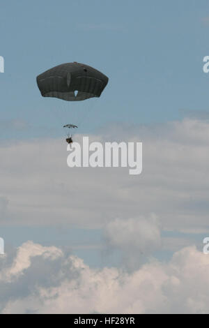 Cpl. Kyle Lenher, a member of 1st Battalion, 503rd Airborne Infantry, 173rd Airborne Brigade, descends through the sky during a water entry training exercise June 24, at a Polish military training camp outside of Drawsko-Pomorskie, Poland. The 'Sky Soldiers' are in Poland at the request of the host nation to participate in combined training exercises with the 3rd Battalion, Princess Patricia's Canadian Light Infantry and Poland's 6th Airborne Brigade. (U.S. Army photo by Sgt. Eric McDonough, Oklahoma Army National Guard/Released) Paratroopers conduct water entry training 140624-Z-VF433-012 Stock Photo